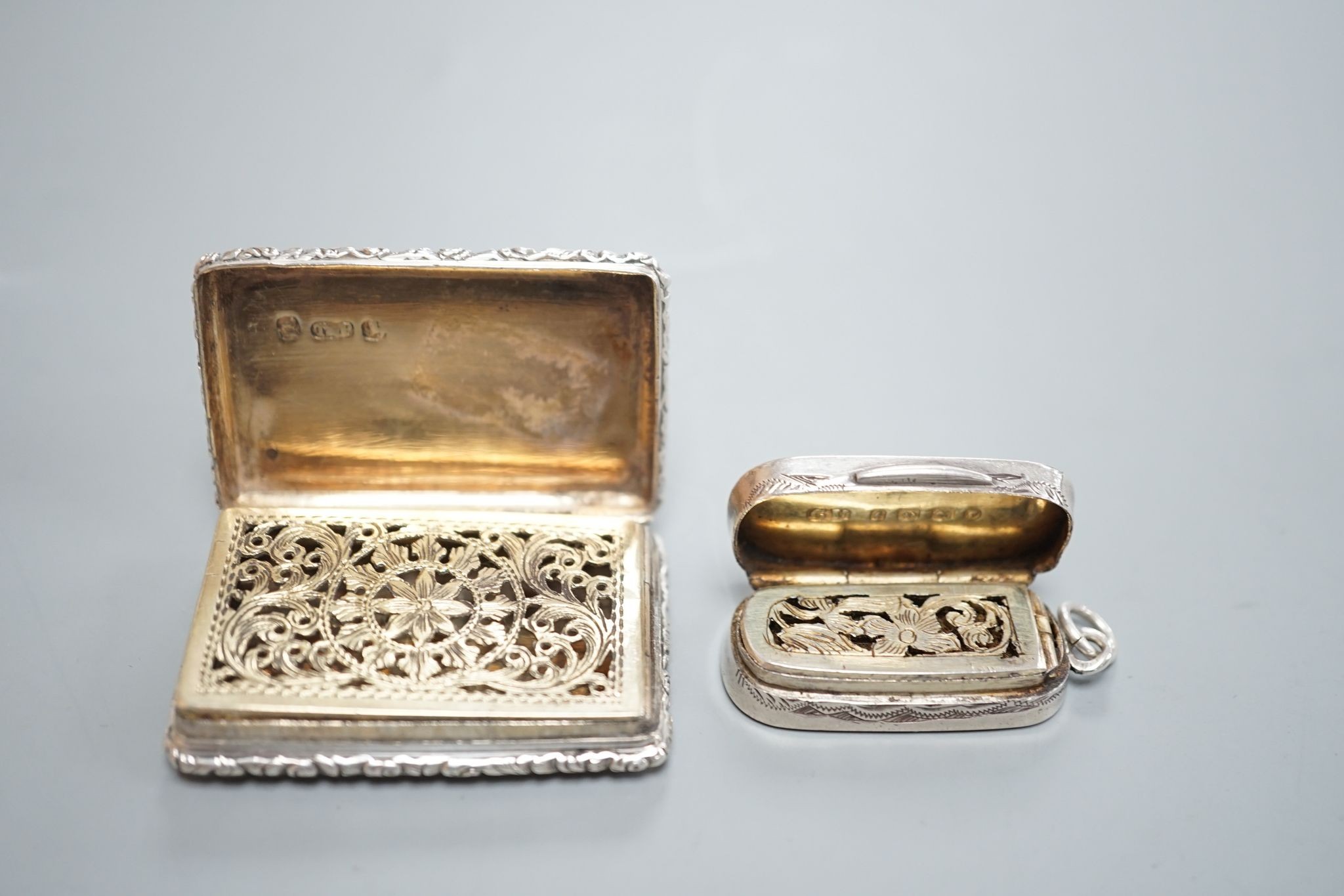 A William IV engraved silver rectangular vinaigrette, with engraved initials, Taylor & Perry, Birmingham, 1833, 42mm and a later oval vinaigrette, by George Unite.